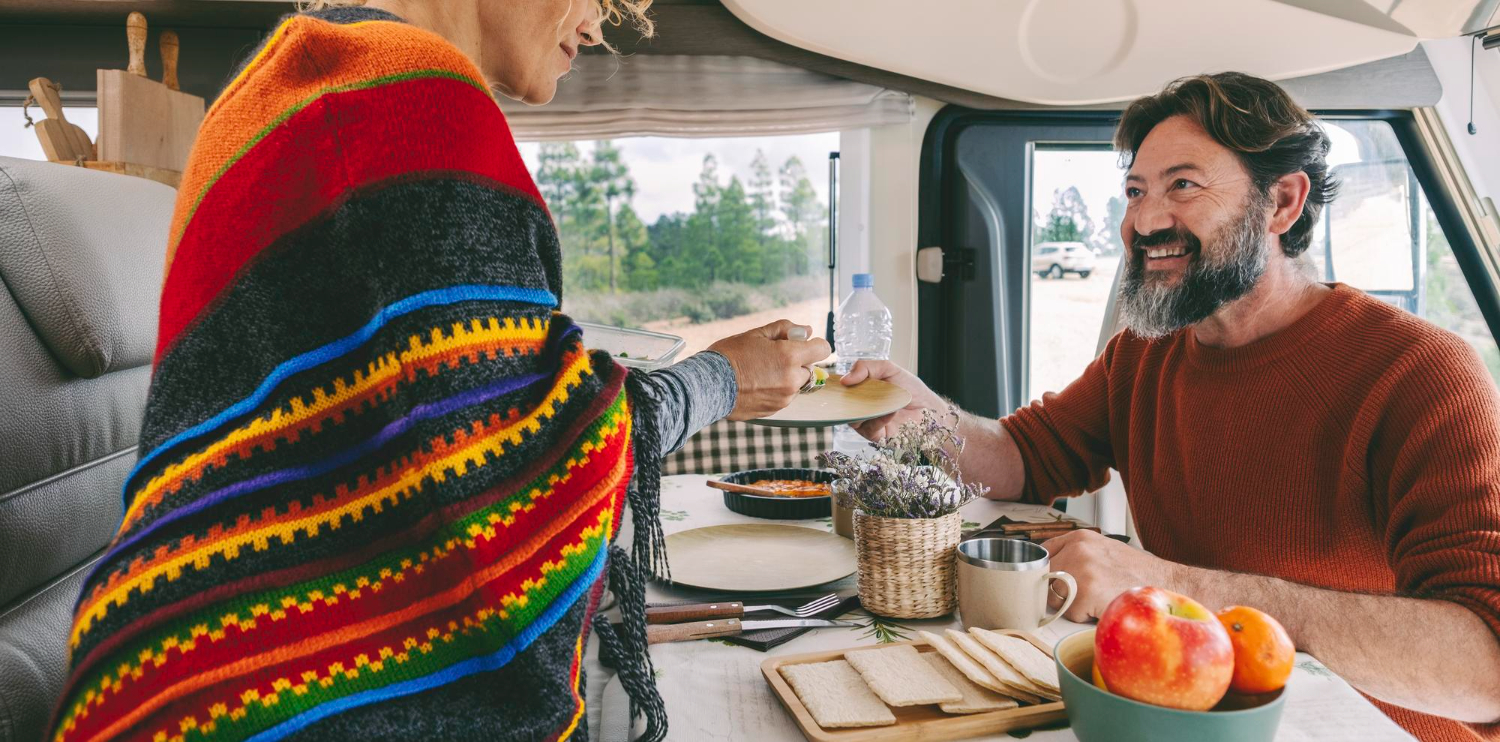 people-in-travel-vacation-leisure-inside-camper-van-enjoying-lunch-together-man-and-woman-with-rent-rv-vehicle-happy-caucasian-couple-in-van-life-off-grid-day-nature-outdoors-outside-the-window.jpg